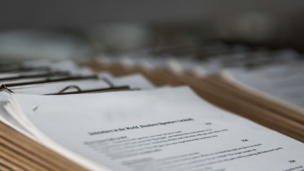 Research papers and printed documents on clipboards representing how AI can summarize academic papers, extract key findings, and simplify complex research.