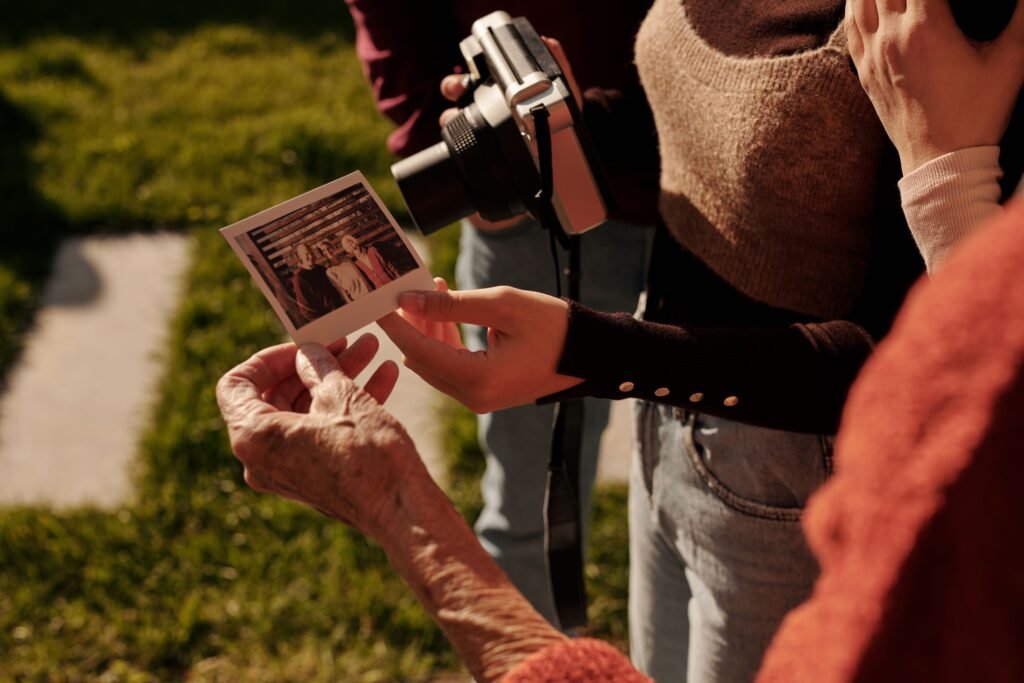 People examining printed photos together, representing collaboration, creativity, and the review of AI-generated images or digital artwork.