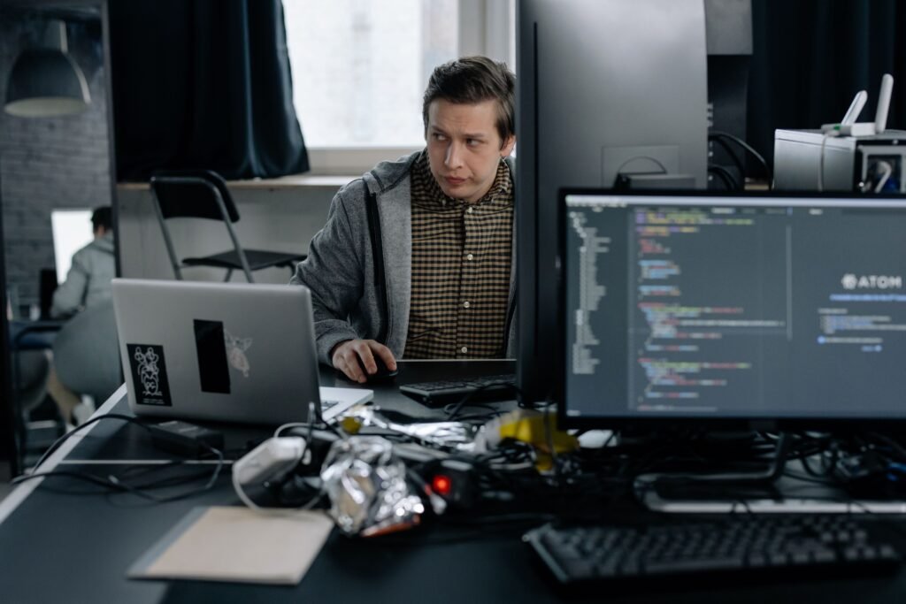 Software developer reviewing AI-generated code on a computer, representing debugging, coding assistance, and AI-powered software development.