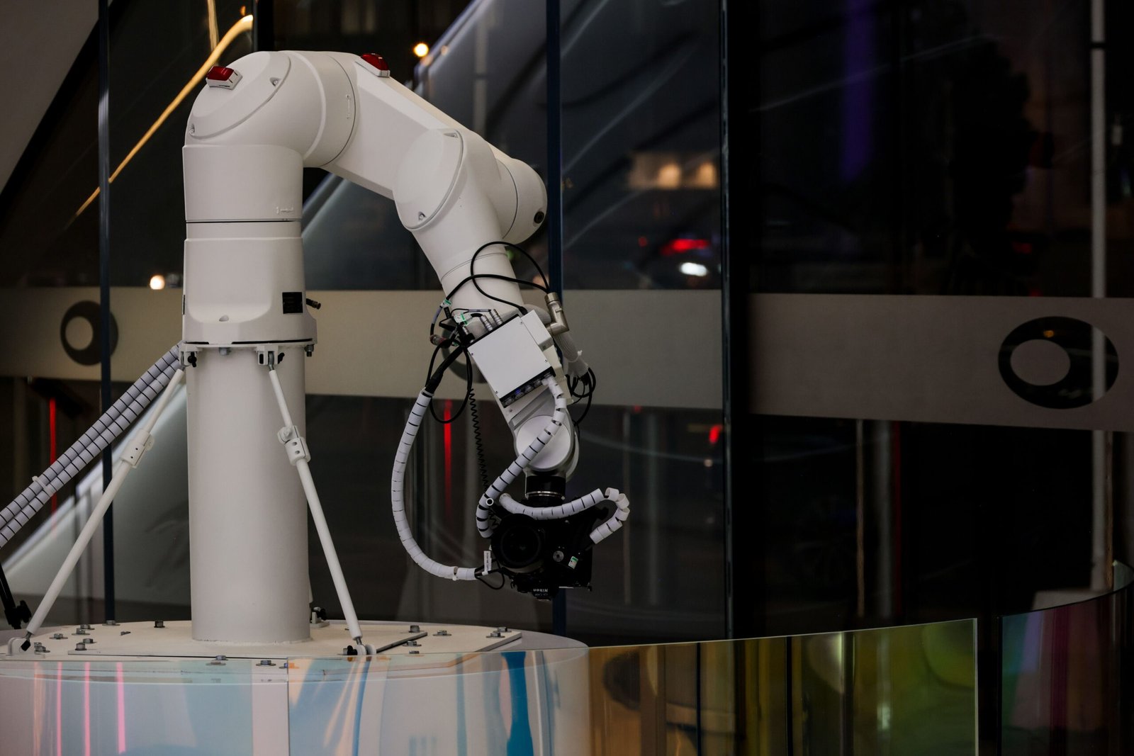 White industrial robotic arm operating in a modern smart factory using AI-powered automation technology