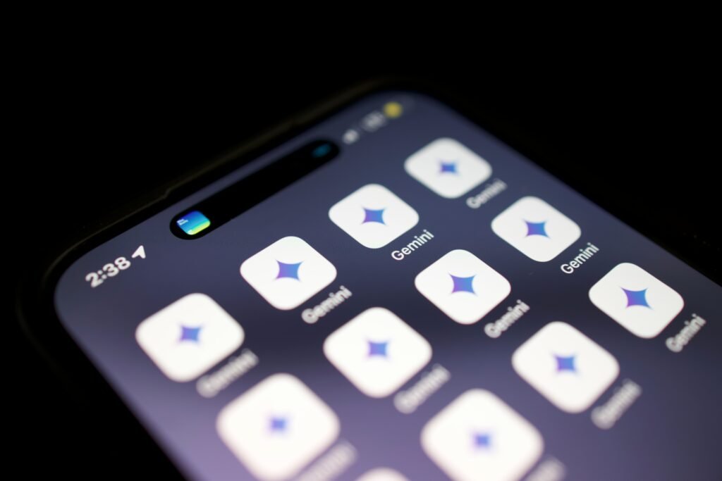 Close-up of a smartphone displaying the Google Gemini app icon, representing Google's AI assistant and generative AI technology.