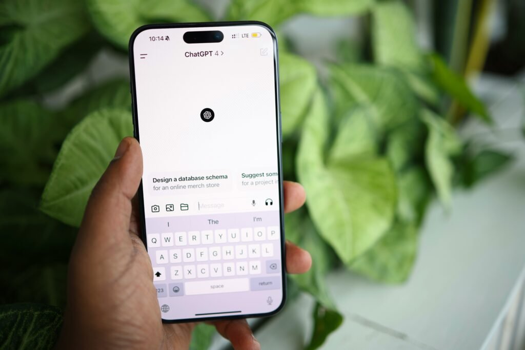 Person holding a smartphone while using the ChatGPT mobile app, illustrating AI-powered learning, studying, and productivity on the go.
