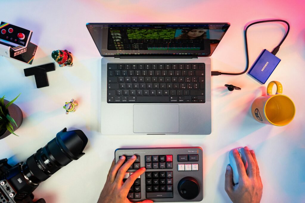 Content creator typing on a keyboard beside a laptop while using Perplexity AI for research, fact-checking, and creating high-quality digital content.