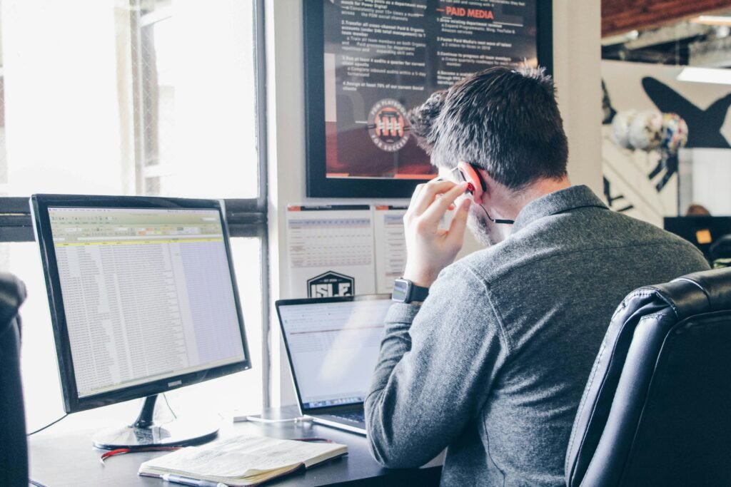 Person troubleshooting an AI application on a desktop computer.
Alt text: Troubleshooting an AI application